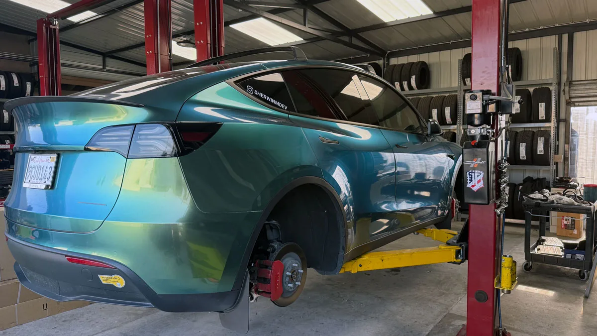 model y on a lift at tire shop