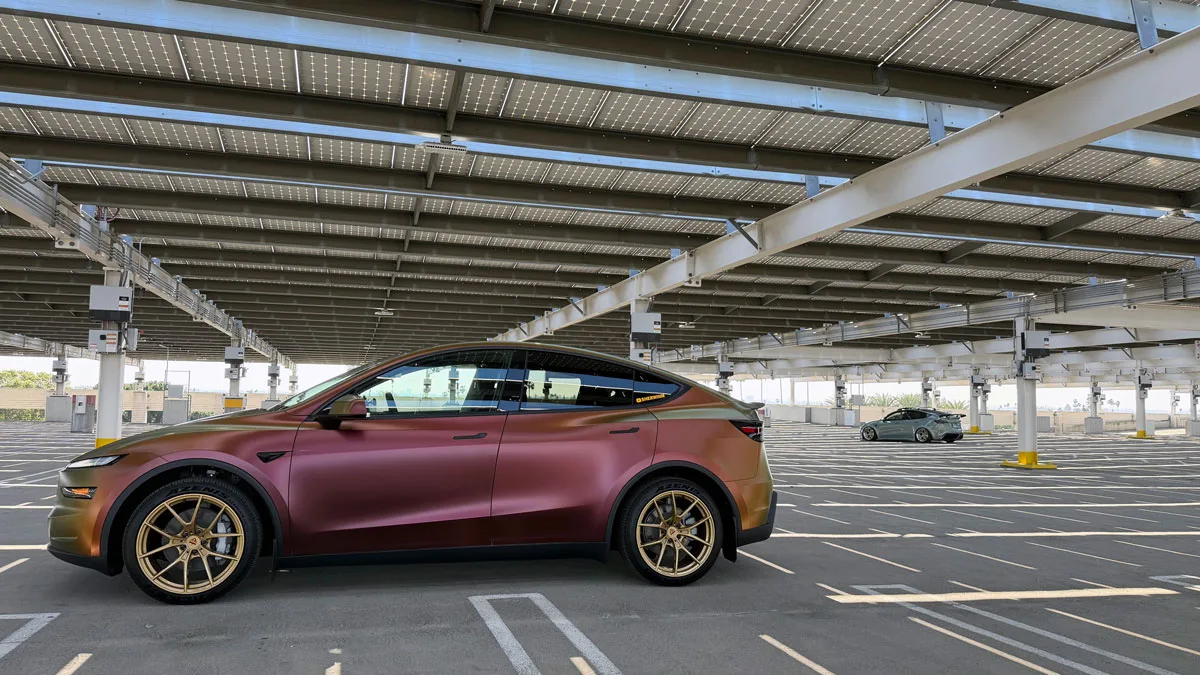 Wrapped Model Y Juniper and Model Y in the back in a parking lot