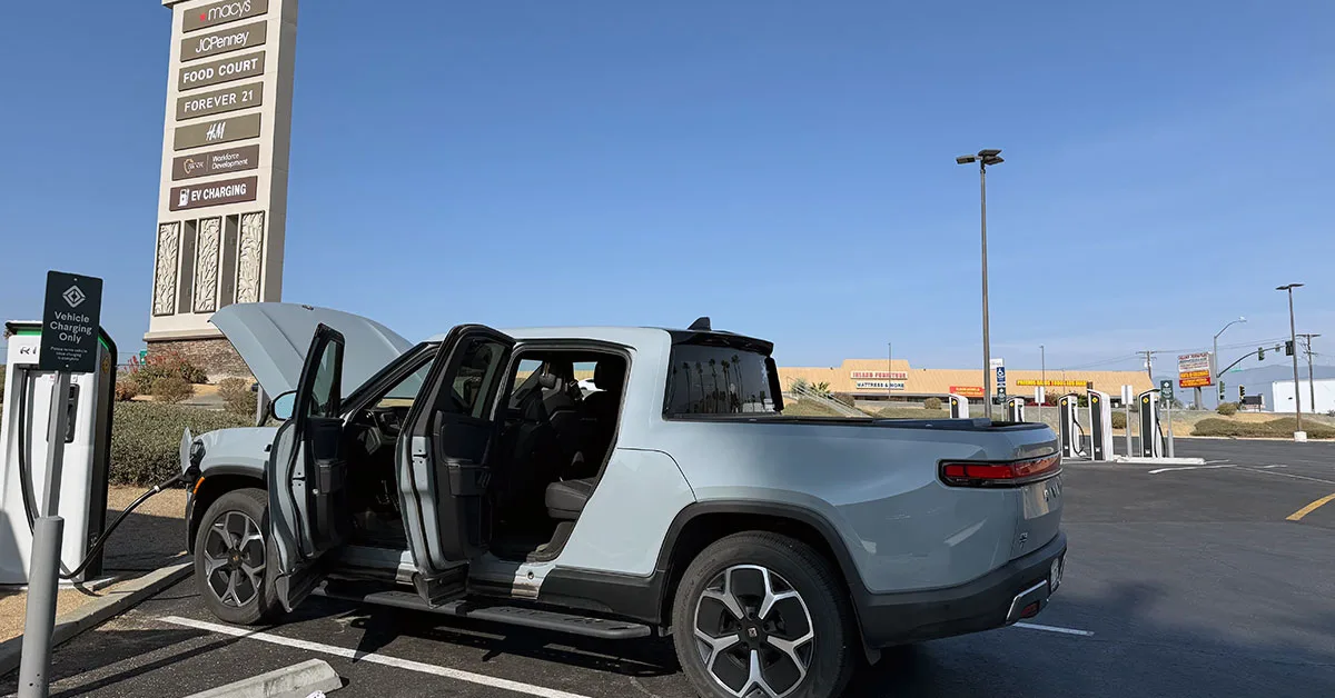 Electric truck charging at station.