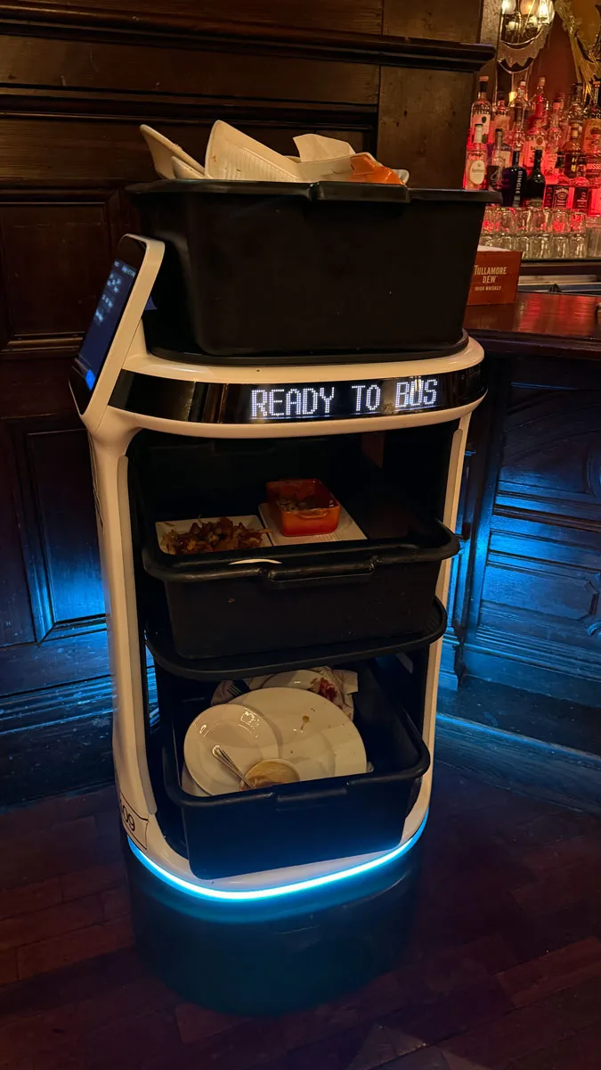 robot bus cleaning tables at restaurant