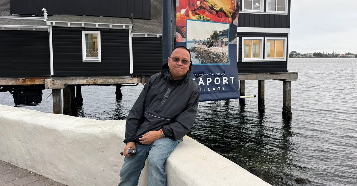 Person sitting by the water.